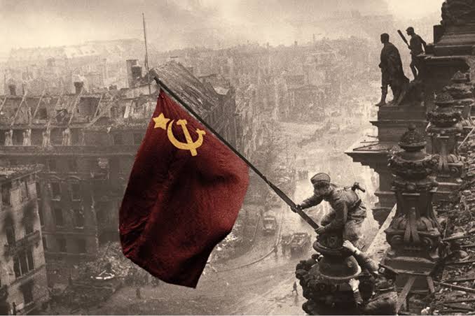 Soviet soldiers raising the flag over the ruins of Berlin in 1945